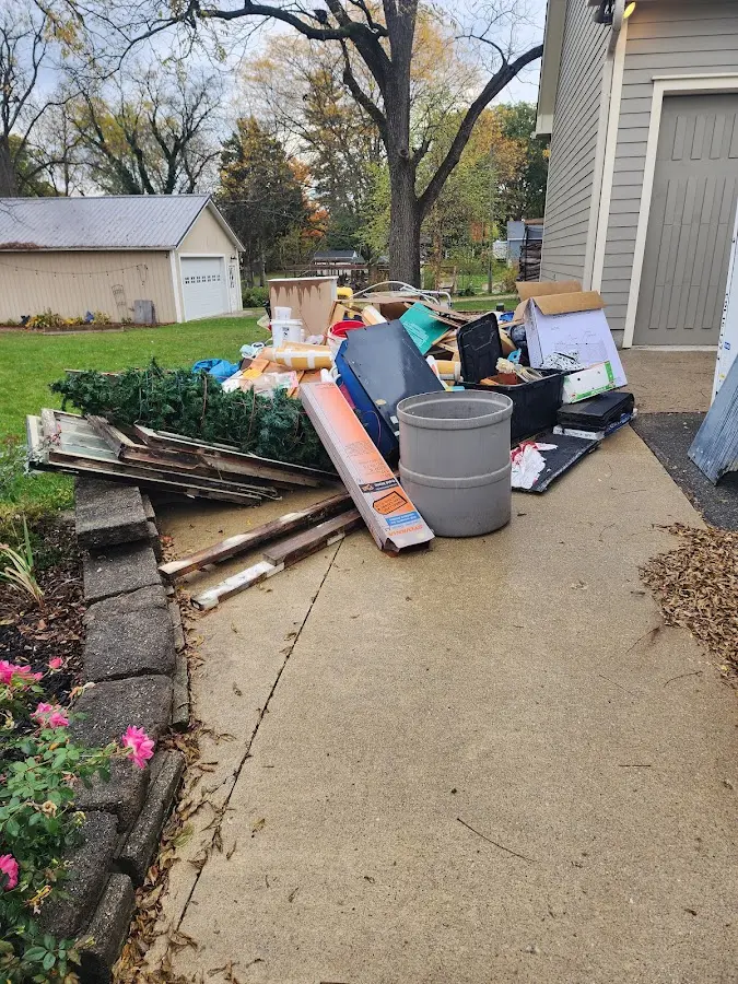 Dumpster being loaded with debris for Estate Cleanout Dumpster Rental in Sandston